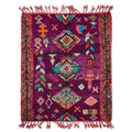 Vivid purple Boujaad rug with multicolor diamonds and dusty pink border, flat lay