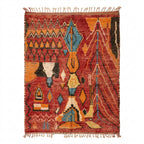 Rust and amber Boujaad rug with teal accents and black tribal motifs, flat lay