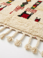 Harvest Symbols Beni Ourain rug fringe detail on white studio background