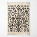 Berber script Azilal rug — ivory wool with dense black tribal symbols, flat lay