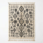 Berber script Azilal rug — ivory wool with dense black tribal symbols, flat lay