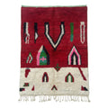 Crimson Boujaad rug — red field with cream base and colorful Berber motifs, flat lay
