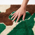Abstract Calm Mrirt rug — hand resting on the soft wool pile