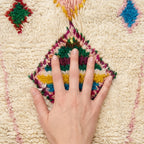 Atlas Diamond Azilal rug — hand resting on the soft wool pile
