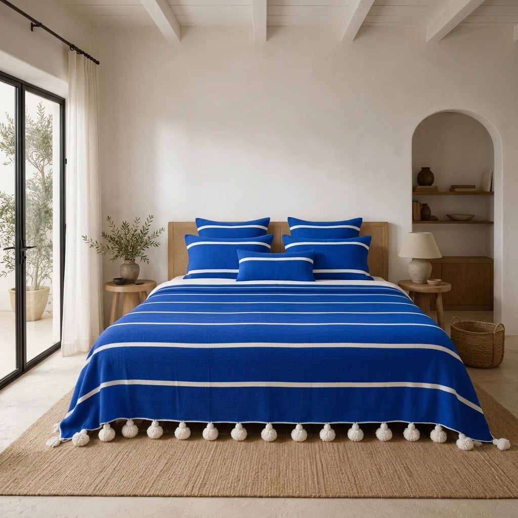 Riviera Stripe Pompom bedspread styled on a bed in a Moroccan bedroom