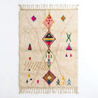 Berber X Azilal rug, handwoven wool with central diamonds, crosses and small multicolor symbols, flat lay top view