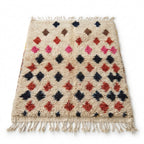 Berry Diamond Azilal rug, handwoven wool with scattered pink, red and navy diamonds, flat lay top view