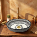 Black and Ivory Fassi Moroccan ceramic vessel sink styled on a bathroom counter in a Moroccan-inspired setting