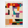 Bold Blocks Azilal rug, handwoven wool with bold orange, purple, pink, green and black blocks, flat lay top view