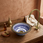 Brass Rim Fessi Moroccan ceramic vessel sink styled on a bathroom counter in a Moroccan-inspired setting