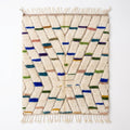 Confetti Dash Azilal rug, handwoven wool with blue, green, teal, mustard and pink dashes, flat lay top view