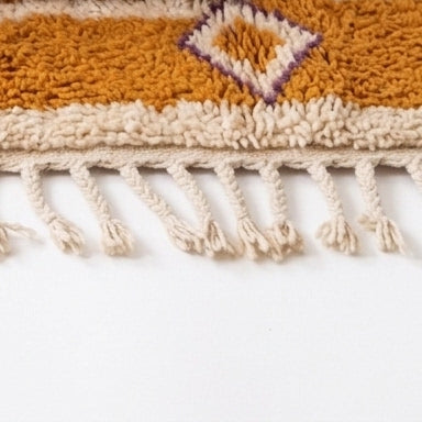 Coral Bloom Azilal rug — rug folded showing wool thickness