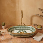 Emerald and Gold Moroccan ceramic vessel sink styled on a bathroom counter in a Moroccan-inspired setting