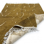 Golden Ochre Mrirt rug — folded corner showing plush pile depth