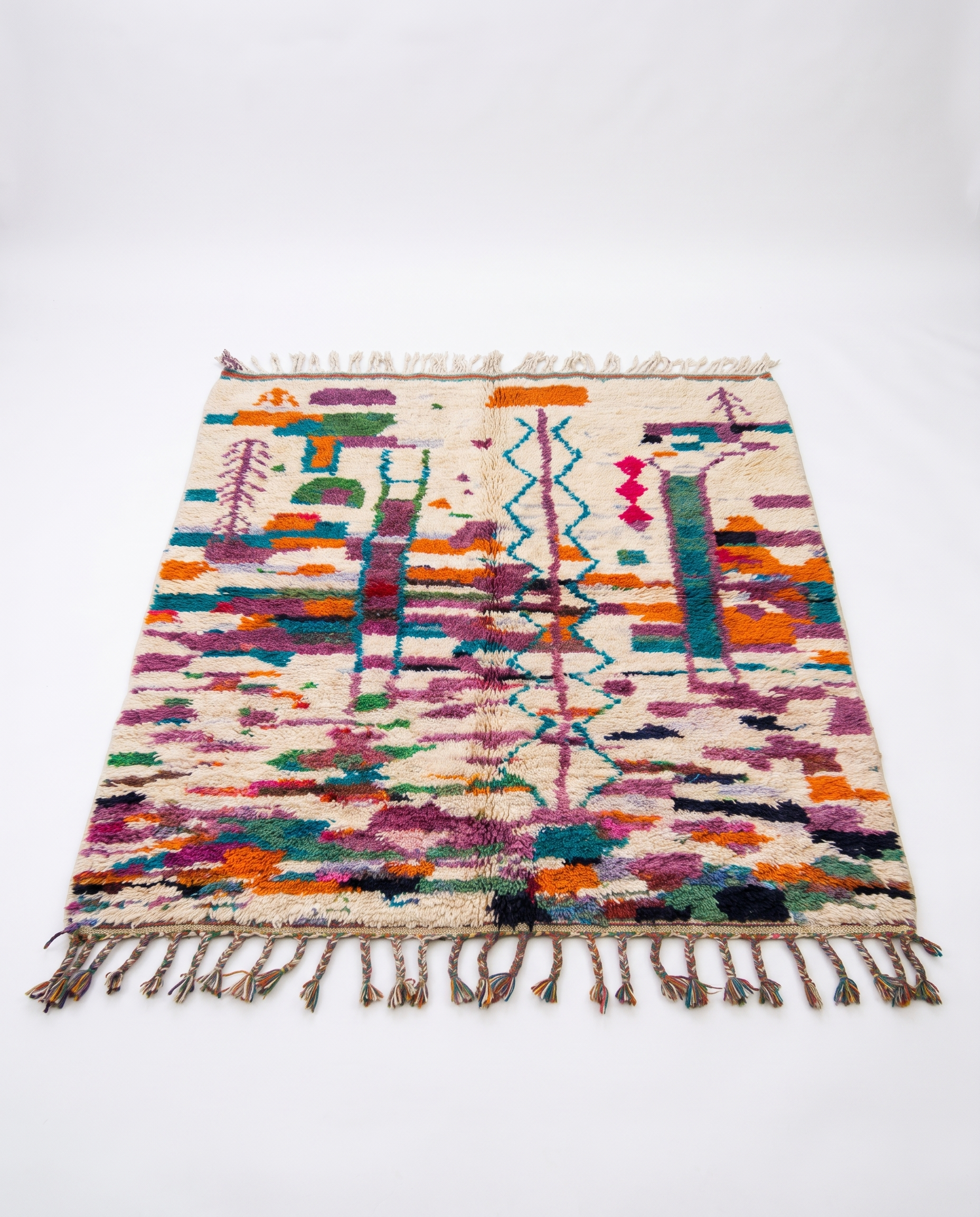 Colorful Boujaad rug full view at an angle on white studio background