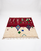 Burgundy and ivory Boujaad rug full view at an angle on white studio background