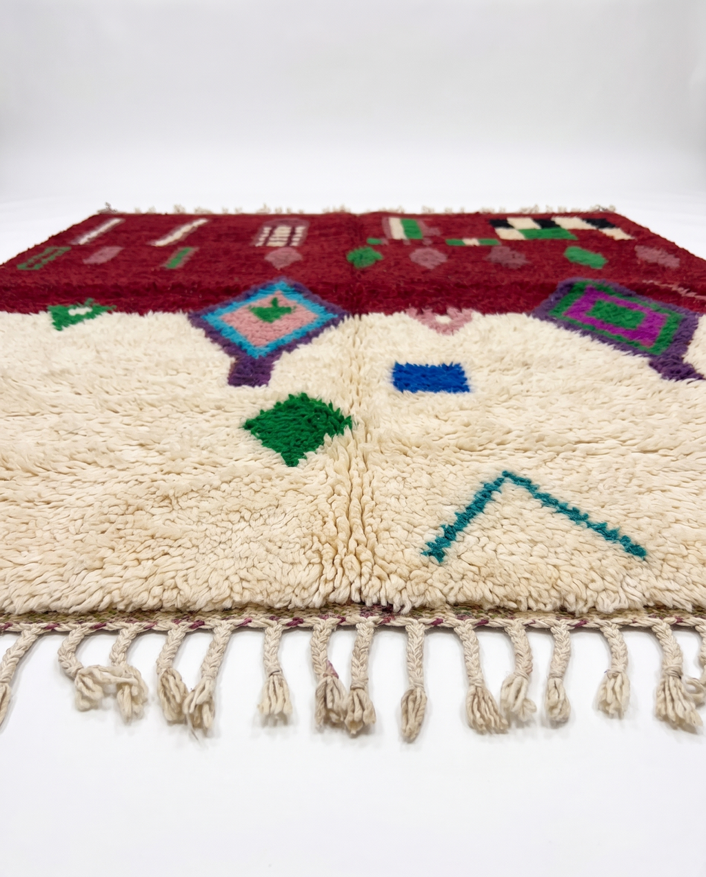 Burgundy and ivory Boujaad rug side view on white studio background