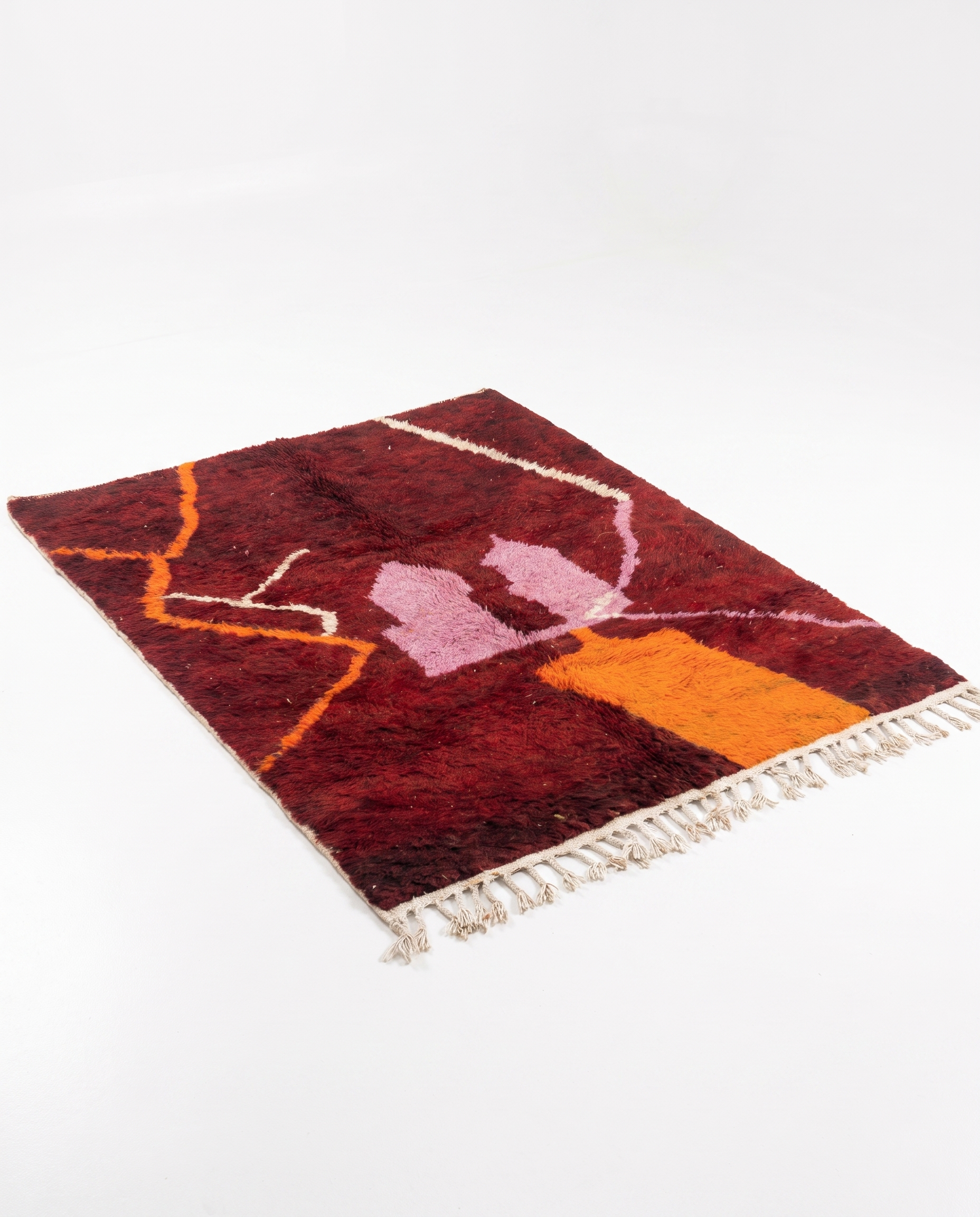 Wine red Boujaad rug full view at an angle on white studio background