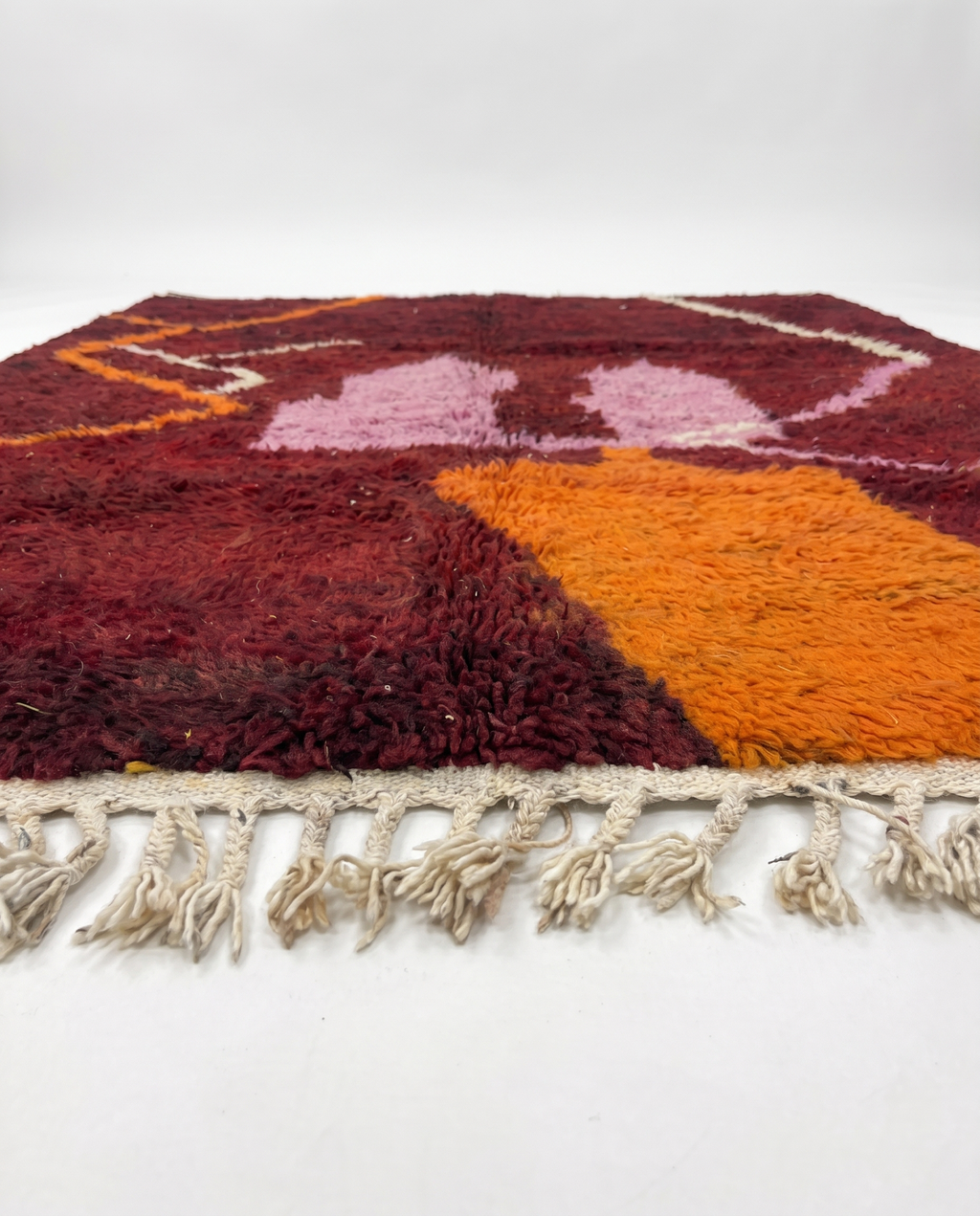 Wine red Boujaad rug side view on white studio background