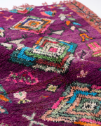 Purple Boujaad rug wool pile texture close-up on white studio background
