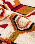 Saffron and ivory Boujaad rug wool pile texture close-up on white studio background
