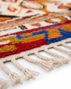Saffron and ivory Boujaad rug fringe detail on white studio background