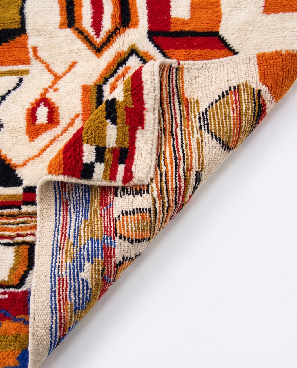 Saffron and ivory Boujaad rug folded corner on white studio background