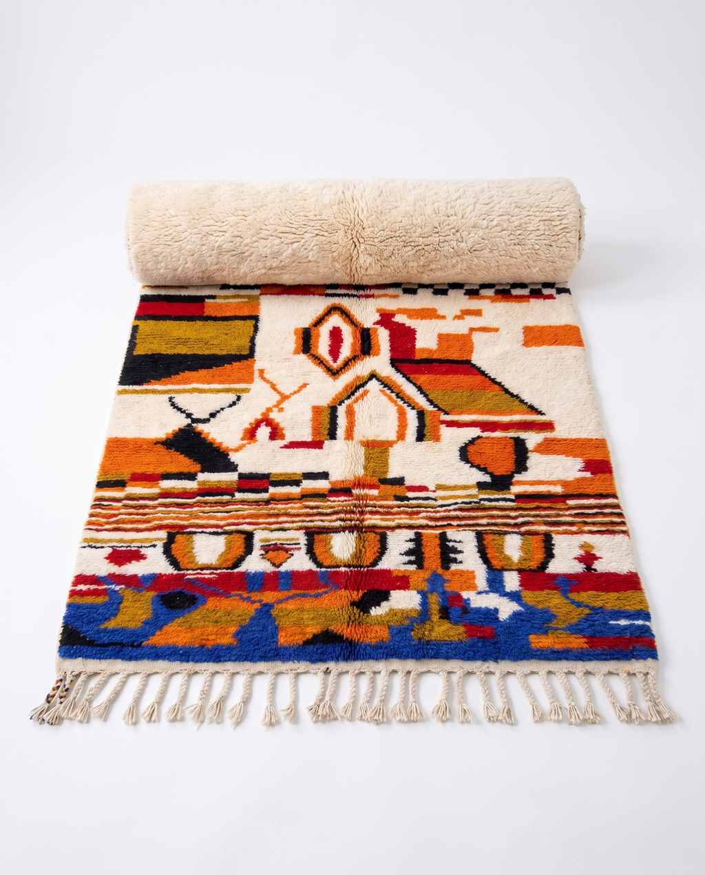 Saffron and ivory Boujaad rug half-rolled on white studio background