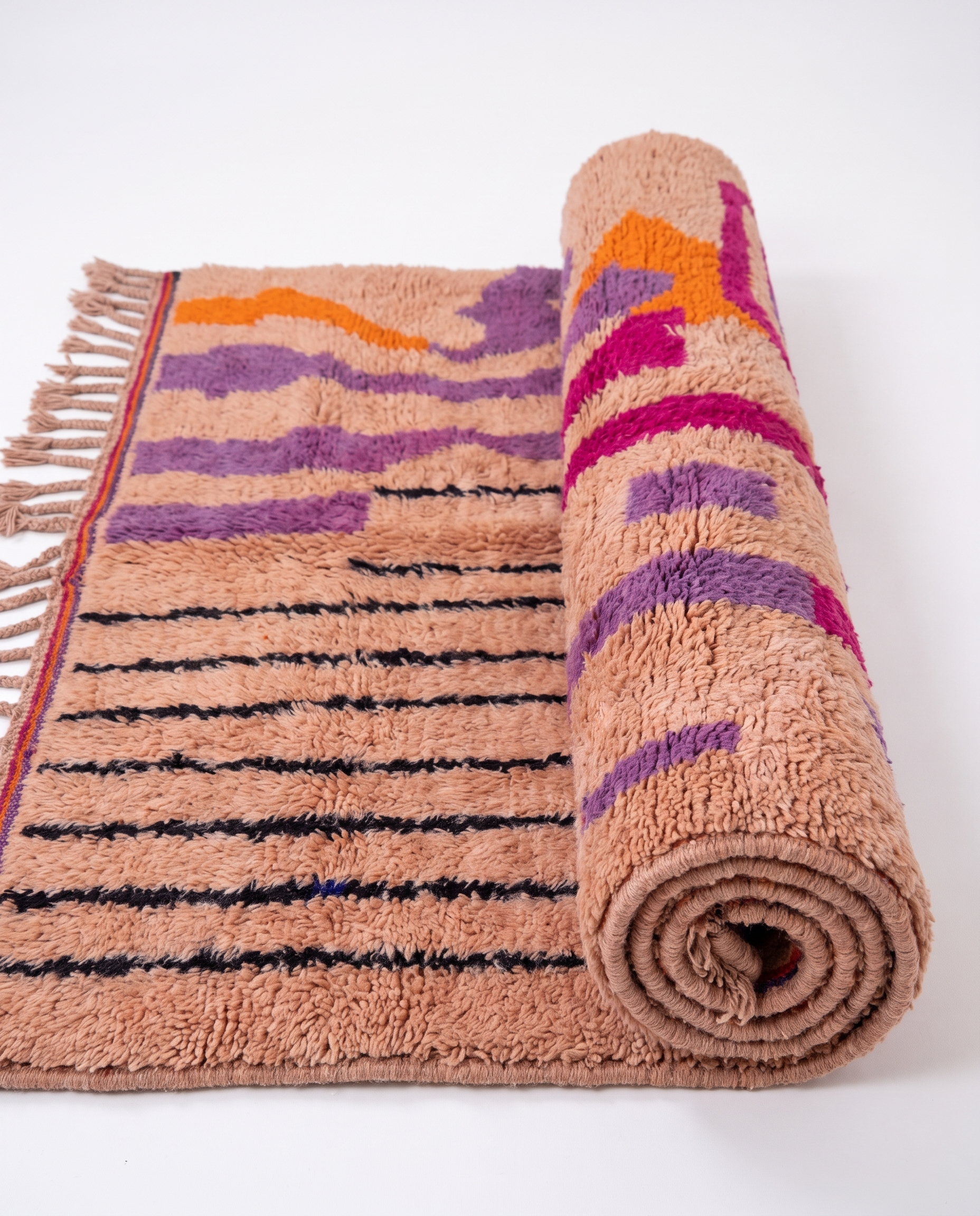 Blush terracotta Boujaad rug half-rolled on white studio background