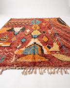 Rust and amber Boujaad rug side view on white studio background