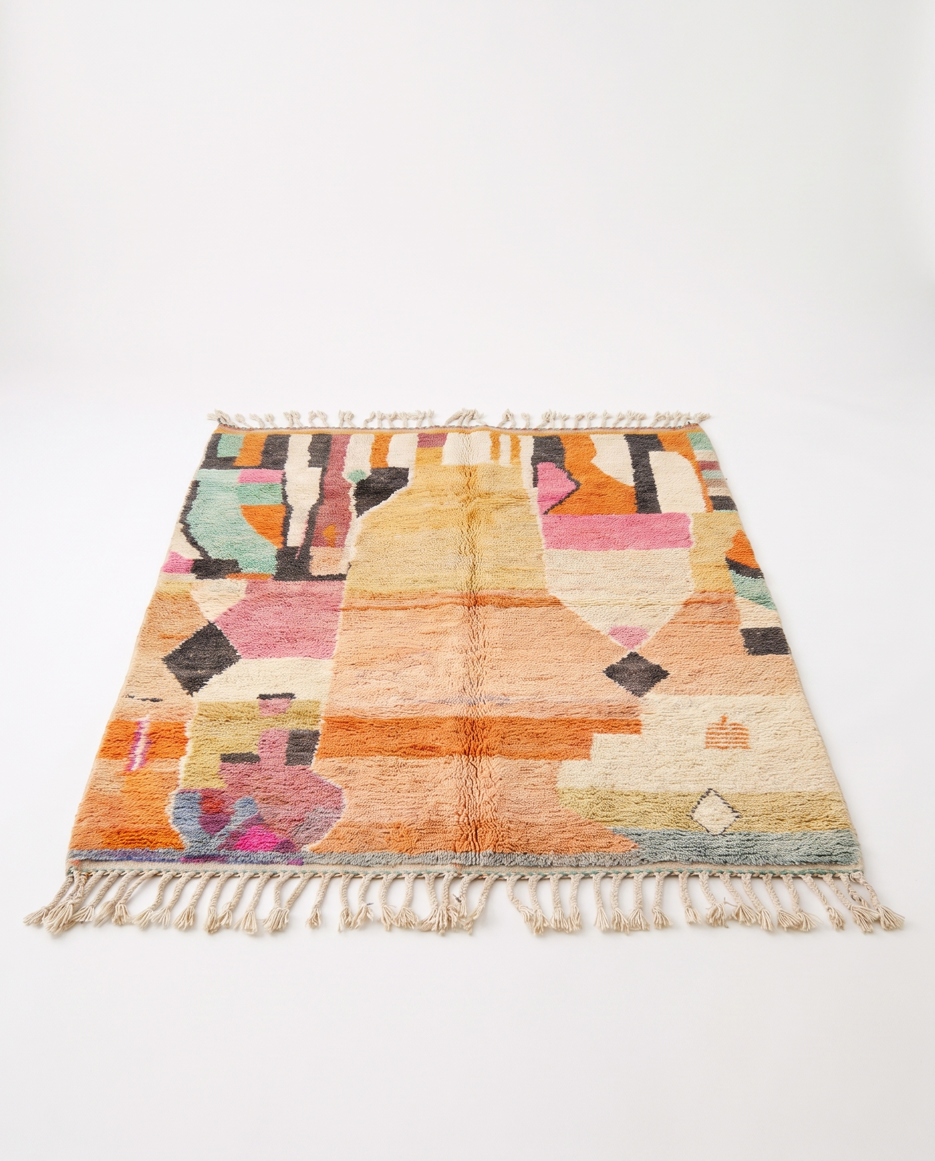Apricot patchwork Boujaad rug full view at an angle on white studio background