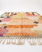 Apricot patchwork Boujaad rug side view on white studio background