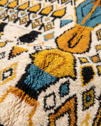 Mustard and teal Boujaad rug wool pile texture close-up on white studio background