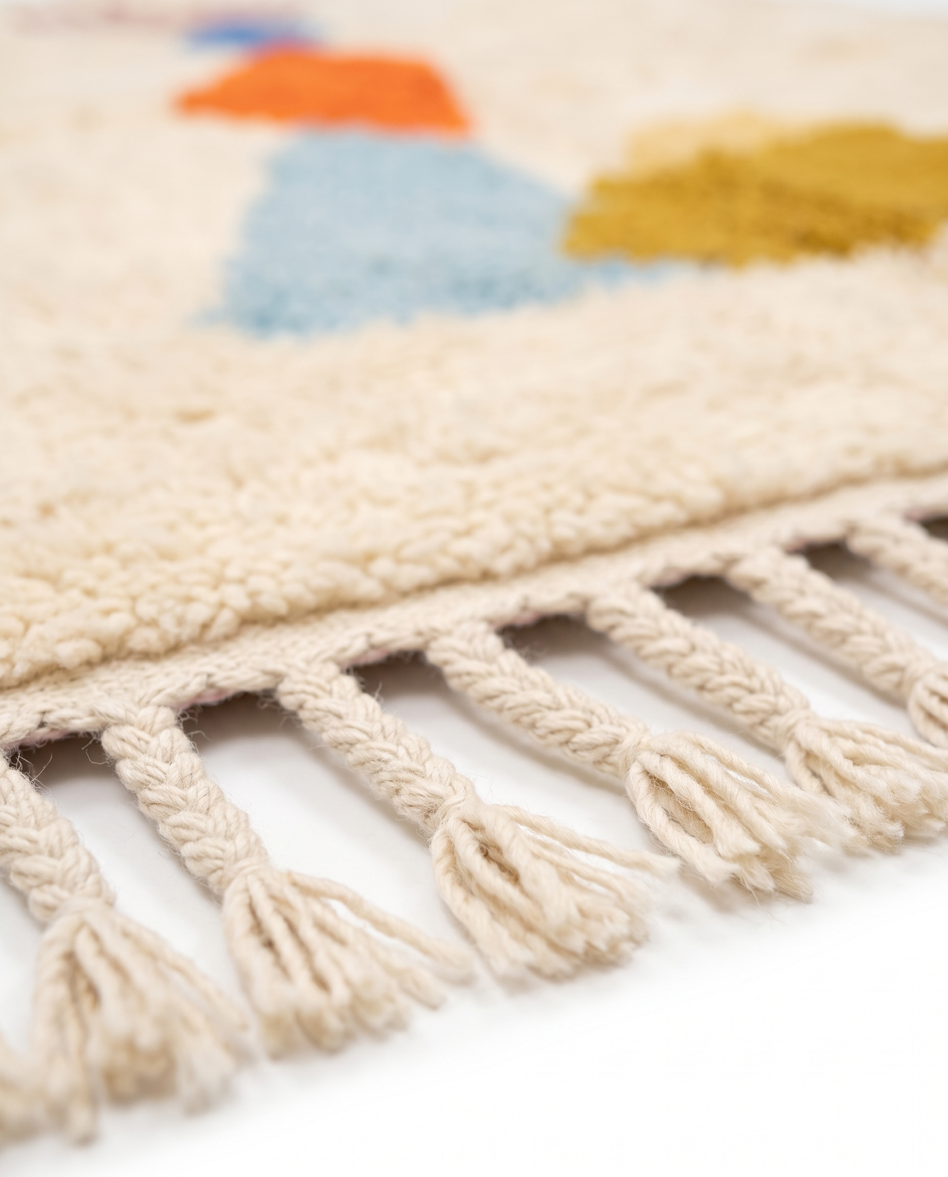 Totem Azilal rug fringe detail on white studio background