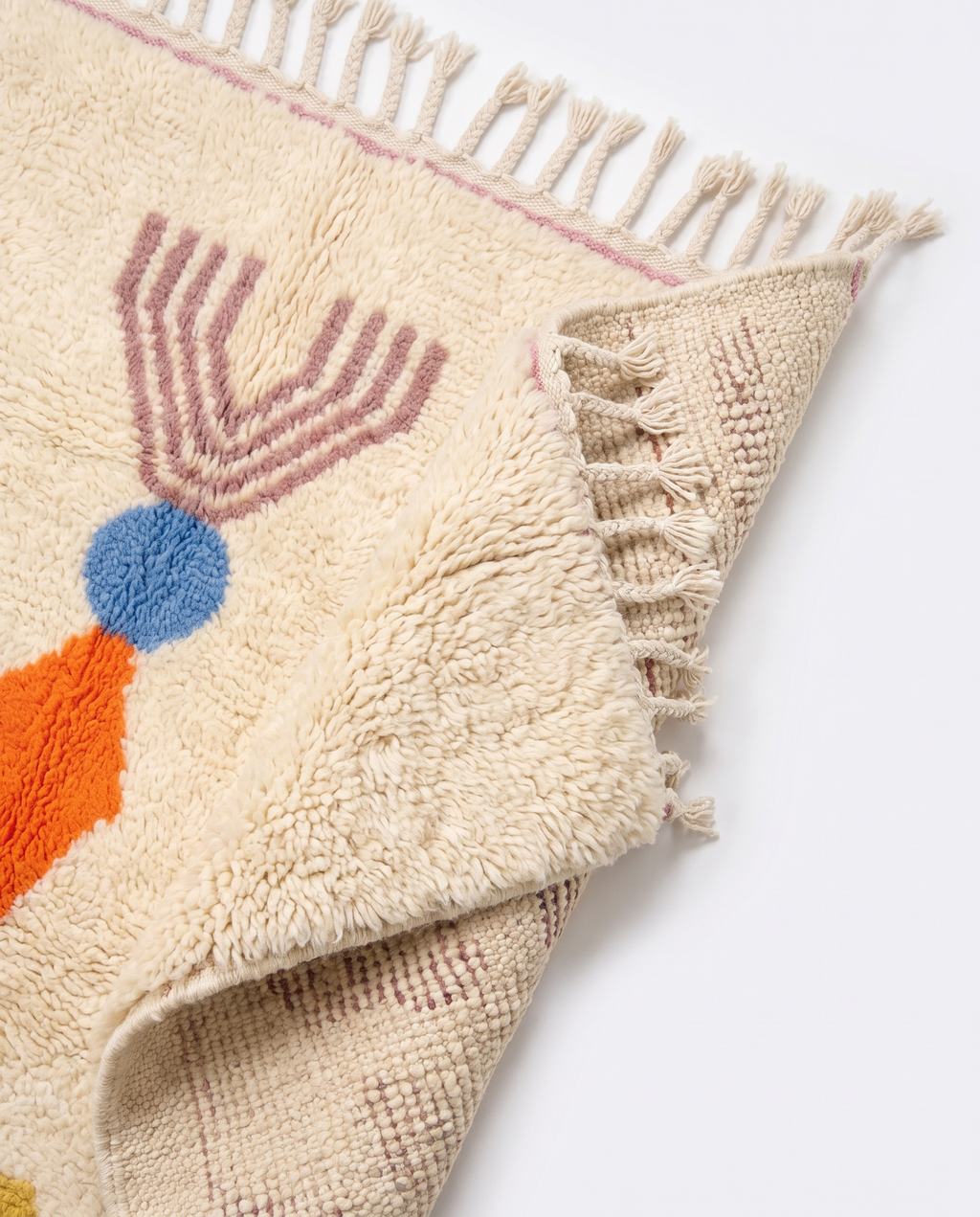 Totem Azilal rug folded corner on white studio background