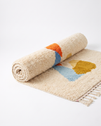 Totem Azilal rug half-rolled on white studio background