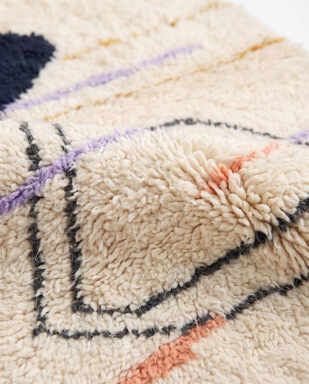 Midnight pebble Azilal rug wool texture close-up on white studio background