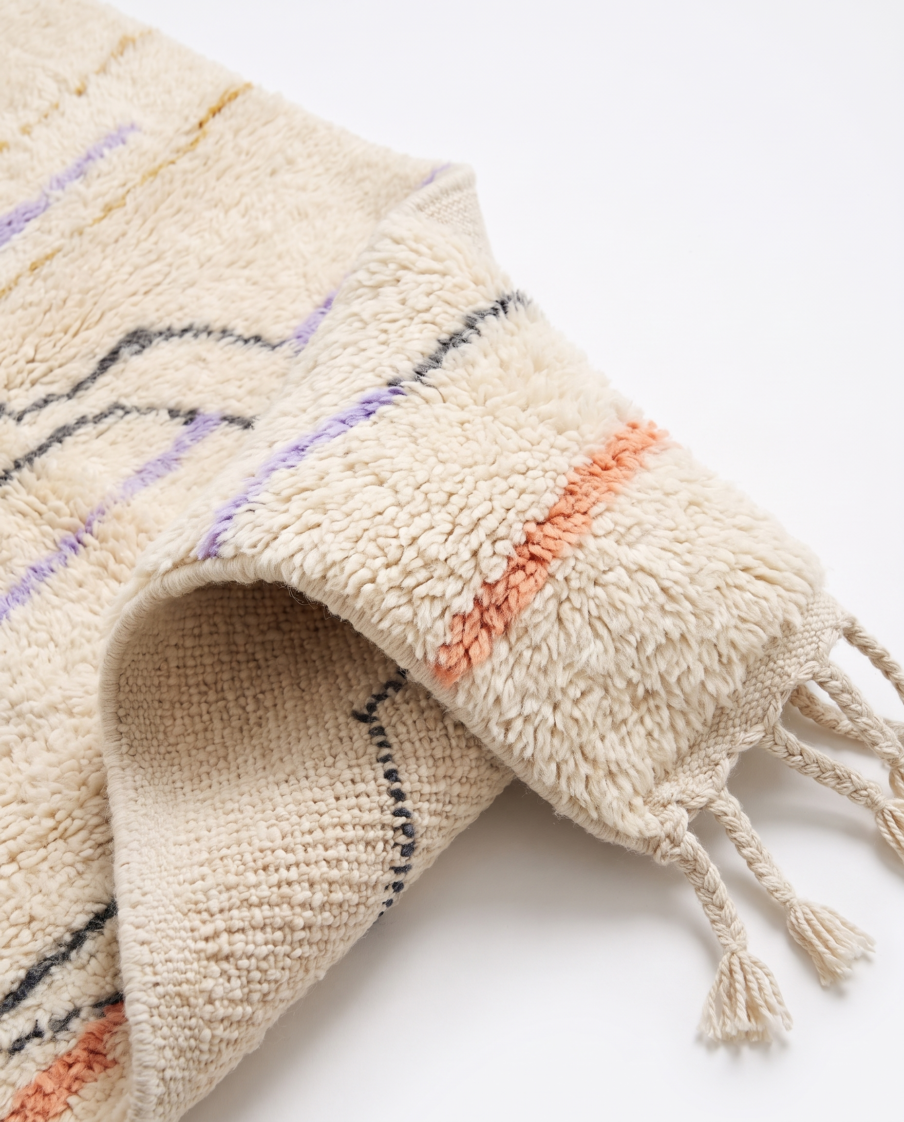 Midnight pebble Azilal rug folded corner on white studio background