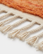 Atlas roots Azilal rug fringe detail on white studio background