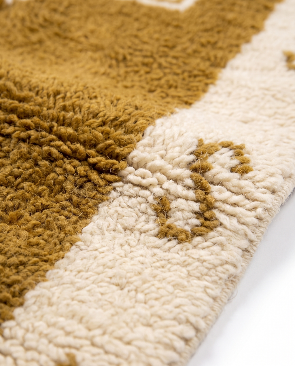 Ochre star Azilal rug wool texture close-up on white studio background