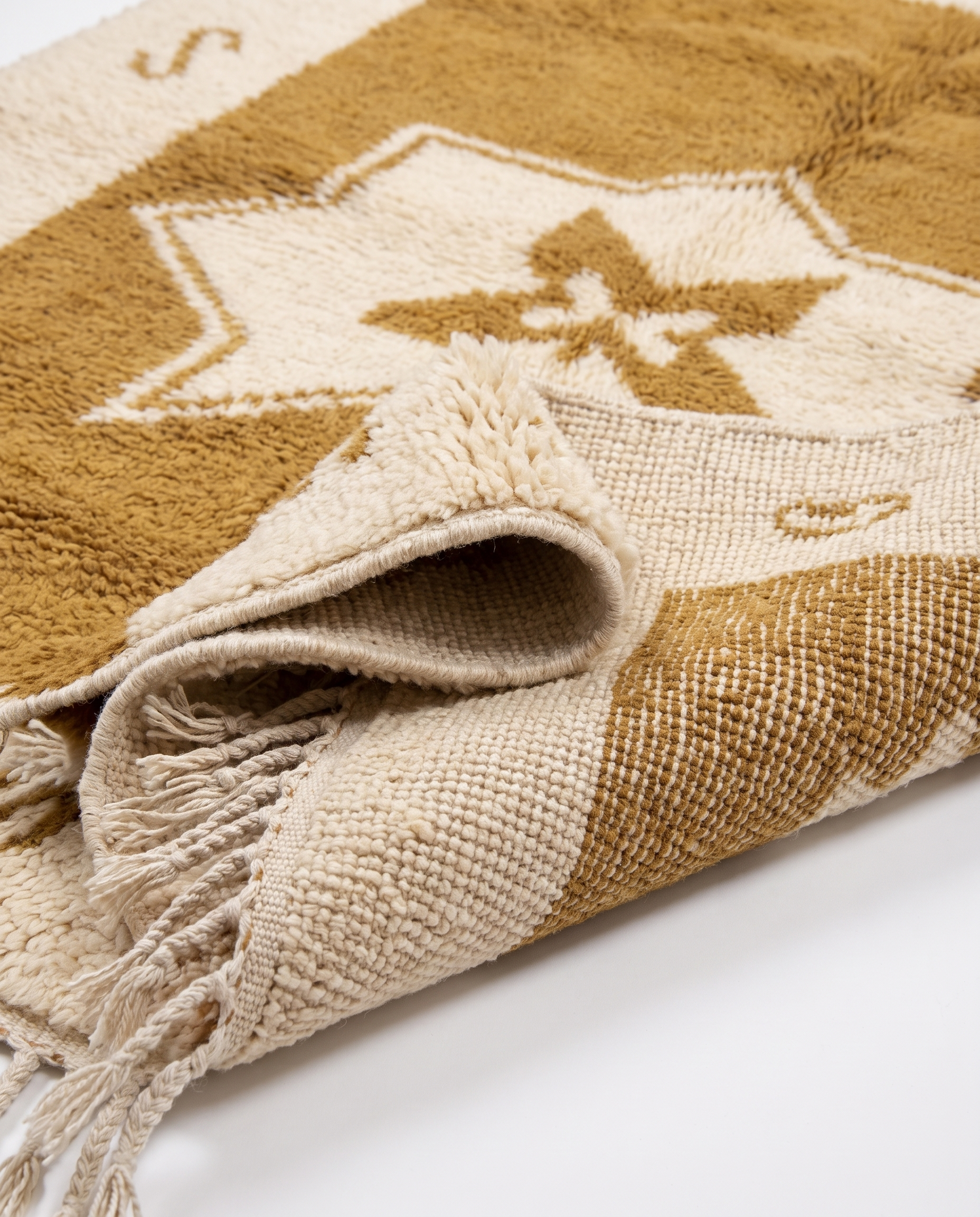 Ochre star Azilal rug folded corner on white studio background