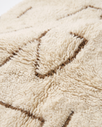 Desert lines Azilal rug wool texture close-up on white studio background