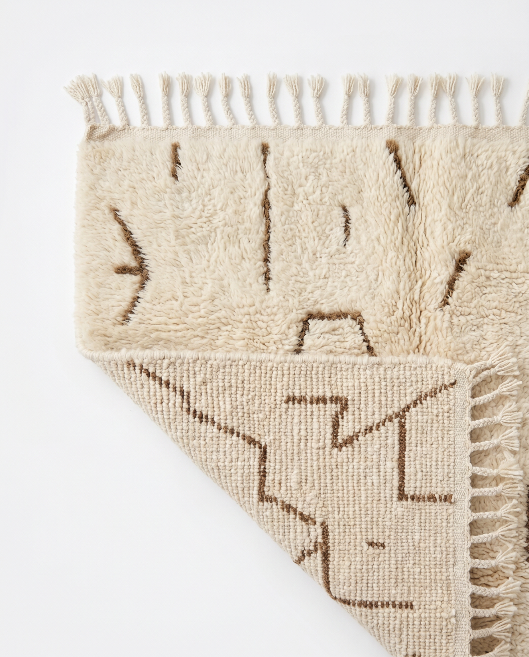 Desert lines Azilal rug folded corner on white studio background