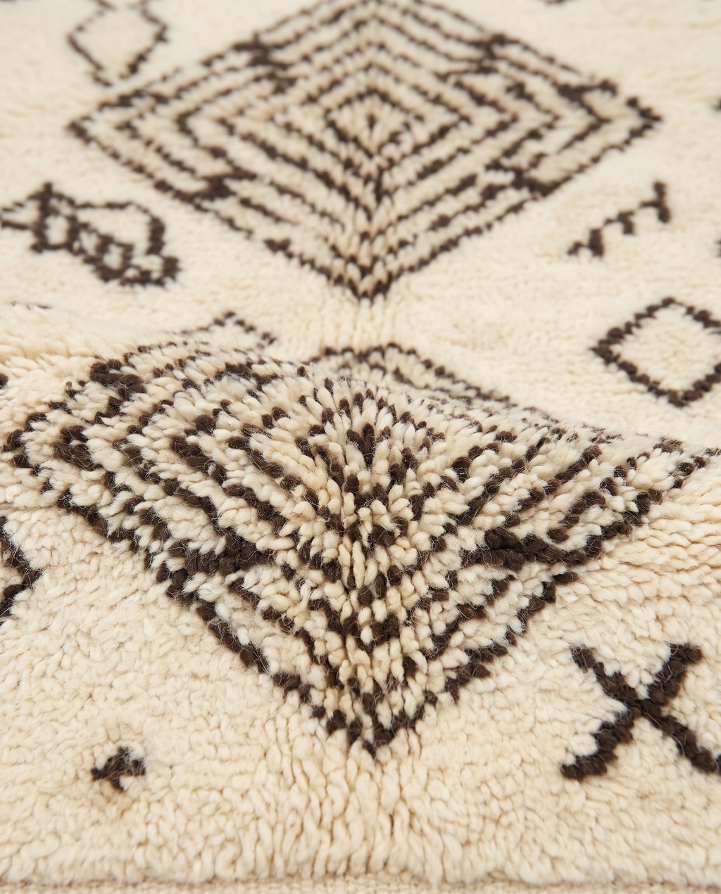 Tribal tales Azilal rug wool texture close-up on white studio background