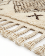 Tribal tales Azilal rug fringe detail on white studio background