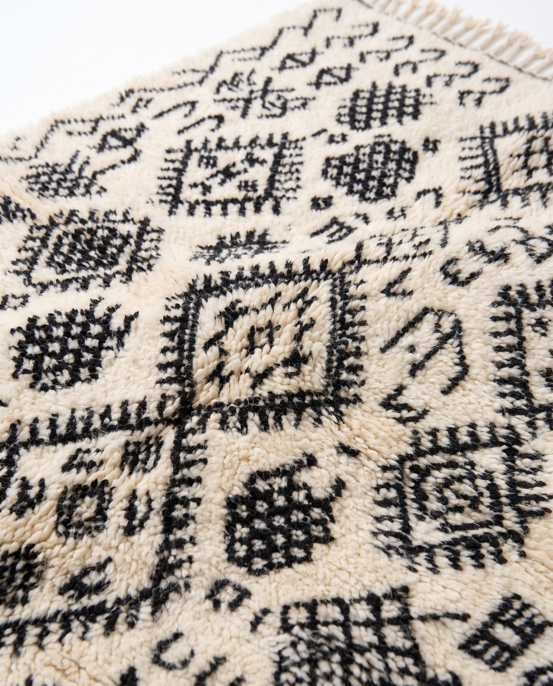 Berber script Azilal rug wool texture close-up on white studio background