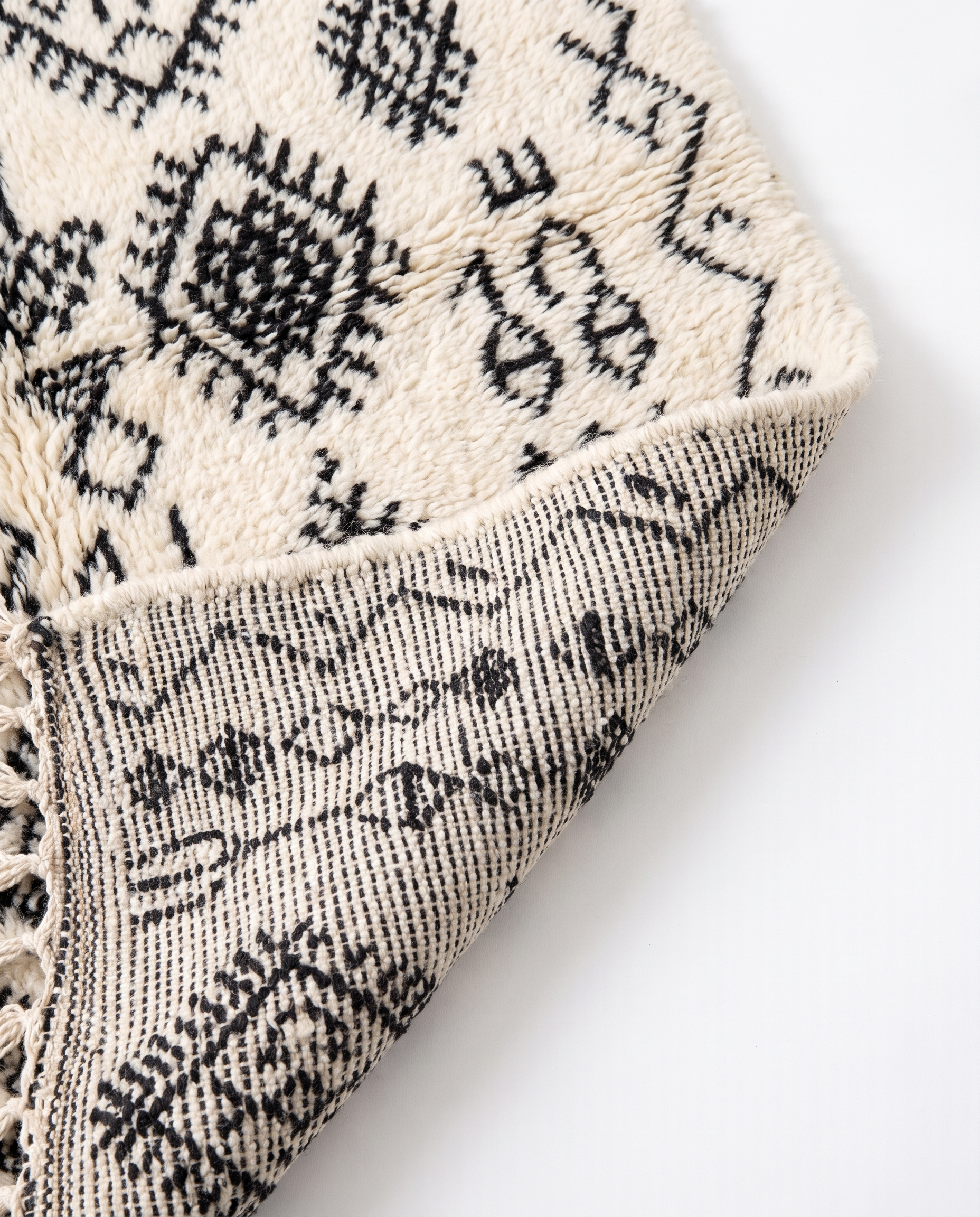 Berber script Azilal rug folded corner on white studio background