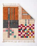 Terracotta Blocks Beni Ourain rug folded corner on white studio background