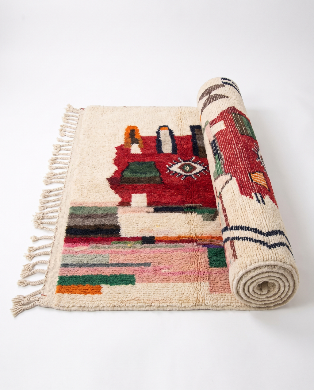 Berber Eye Beni Ourain rug half-rolled on white studio background