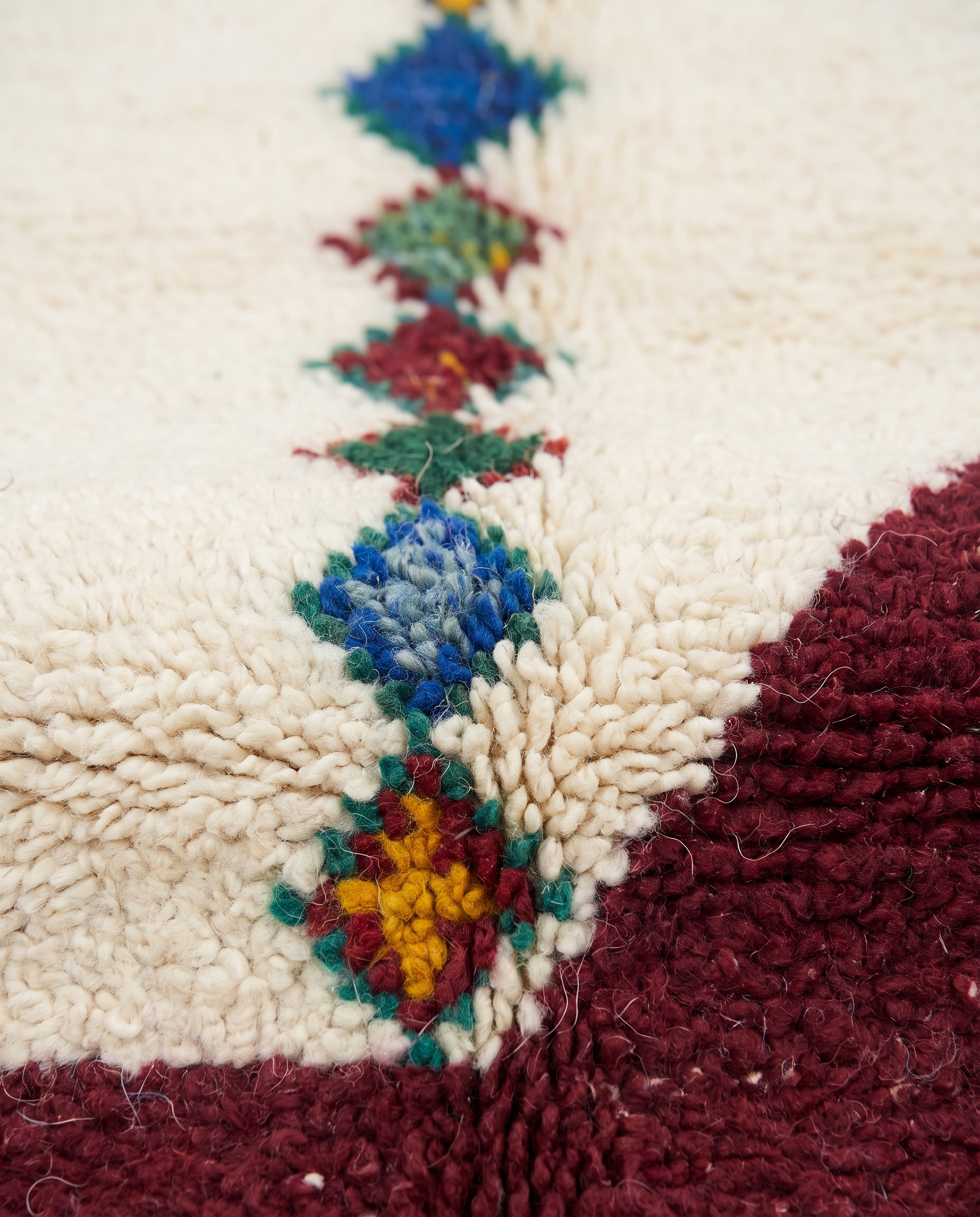 Diamond Totems Beni Ourain rug wool texture close-up on white studio background